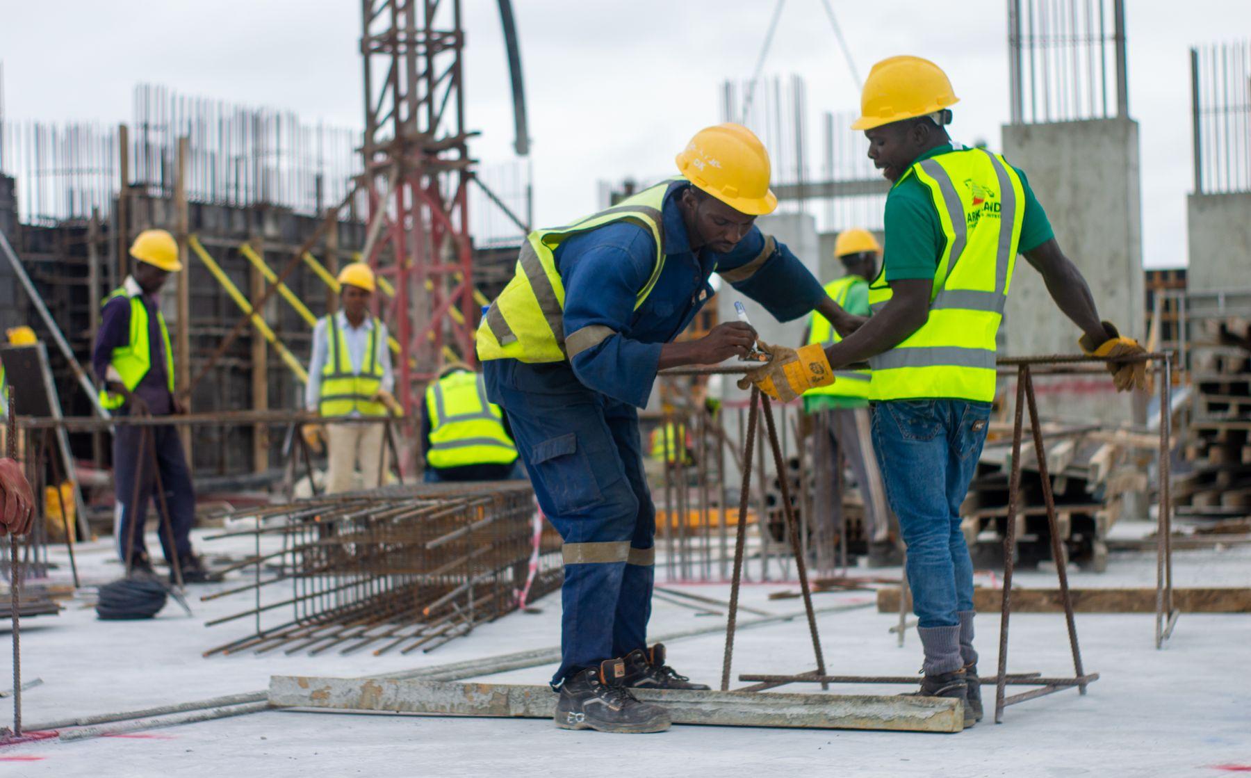 Construction professionals coordinating work on a reinforced concrete building site